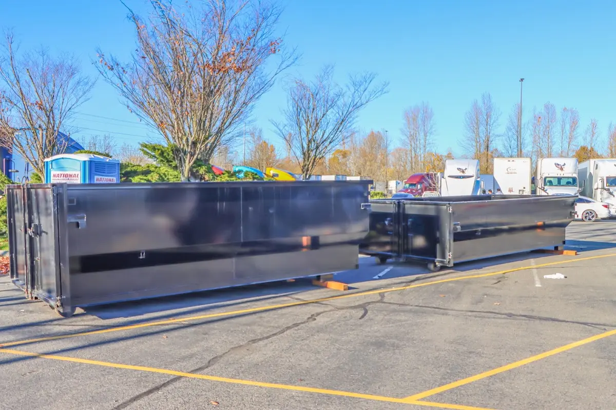 Professional dumpster rental service with roll-off container on residential driveway in Haledon